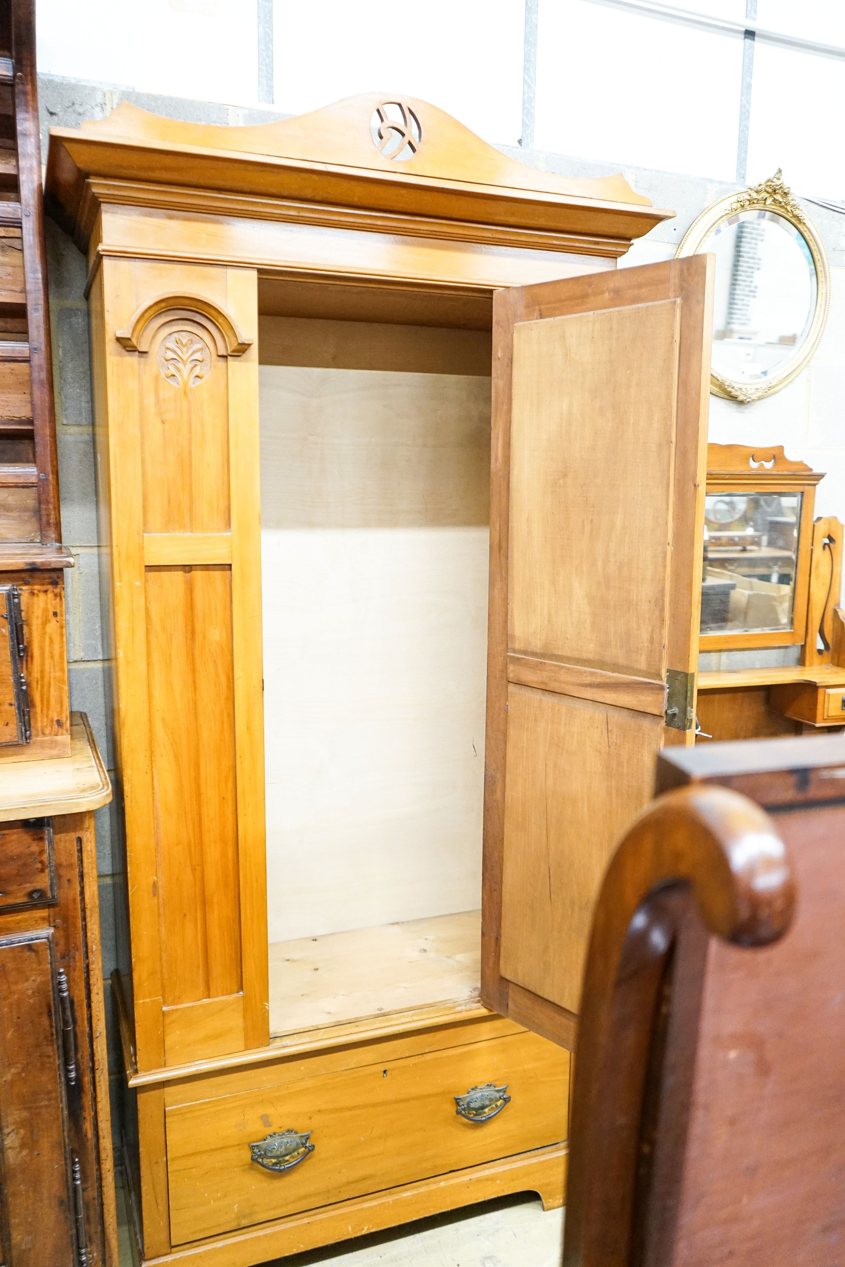 A late Victorian satin walnut mirrored wardrobe, length 105cm, depth 48cm, height 210cm and a dressing table